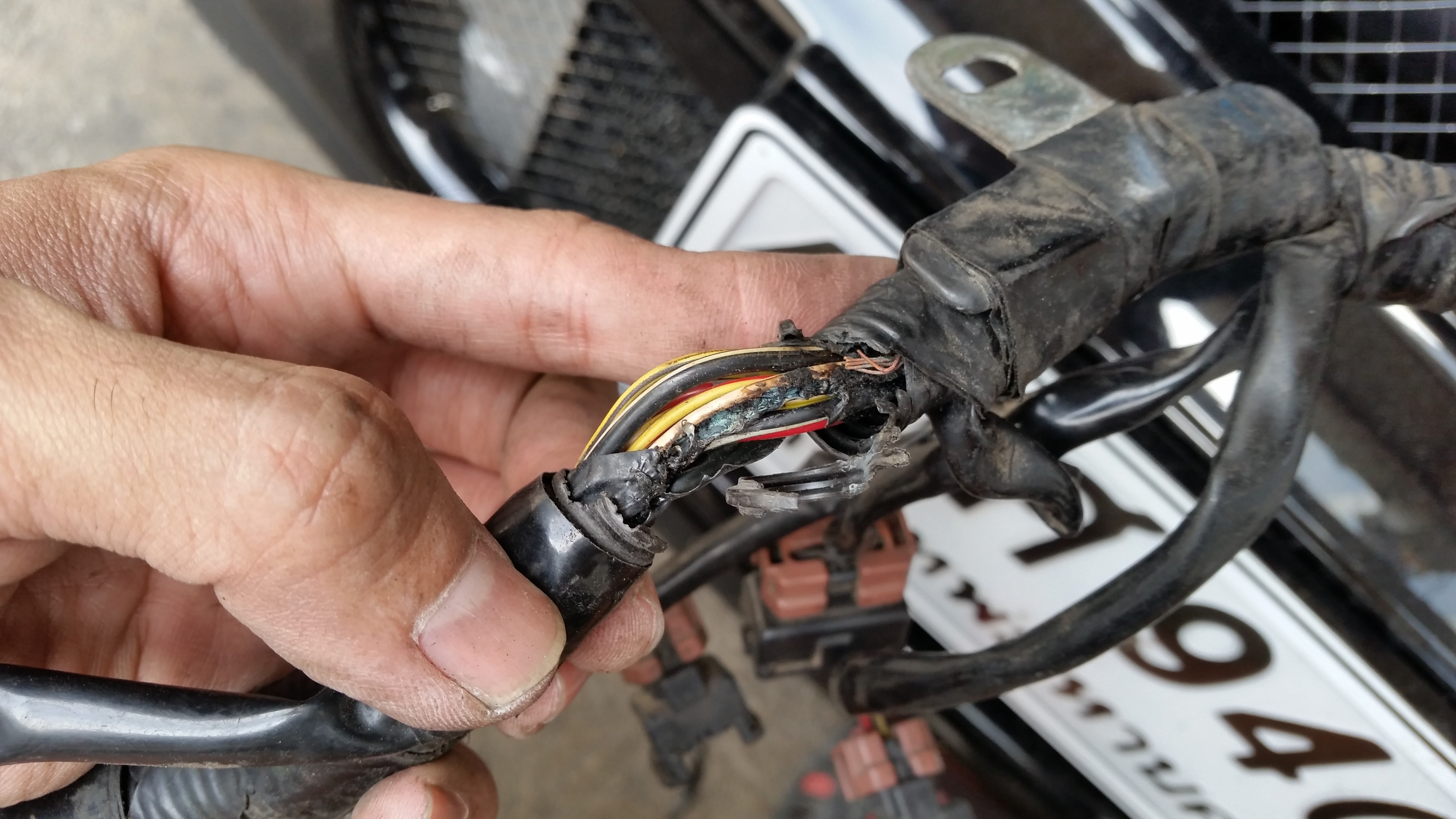 Person handling cable that is broken and has wires exposed.